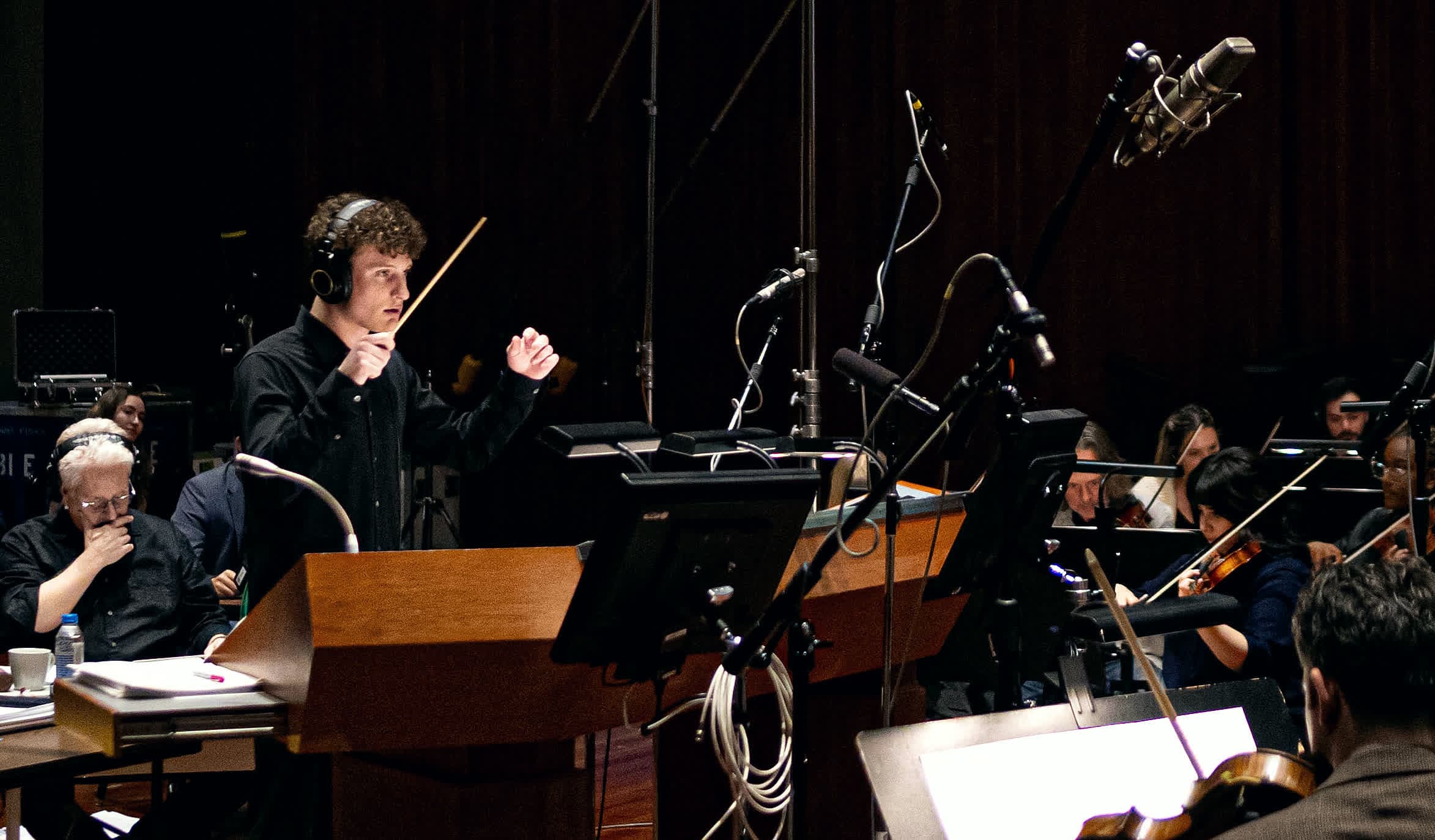 Liam Diethrich conducting an orchestra in the studio